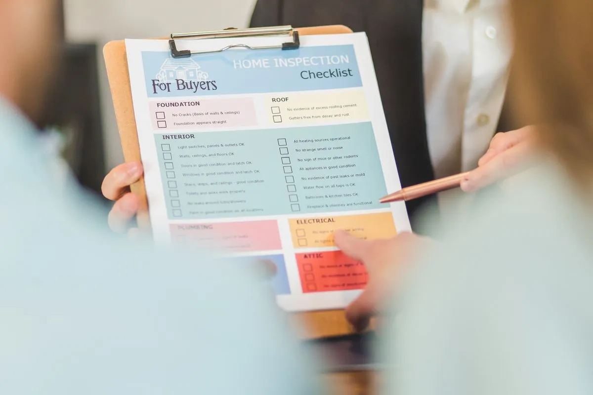 Hand ticking boxes on a paper checklist on a clipboard