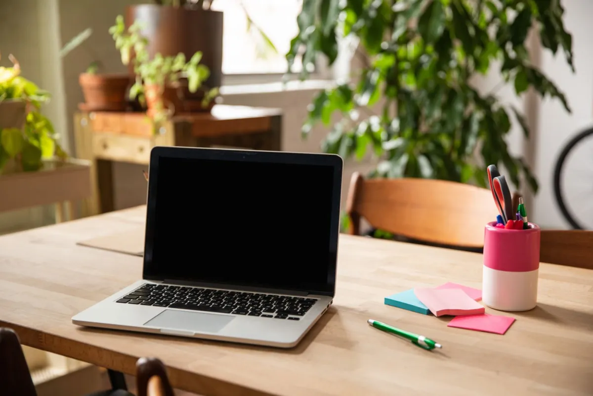 Laptop open on a desk for reviewing a concreter website design