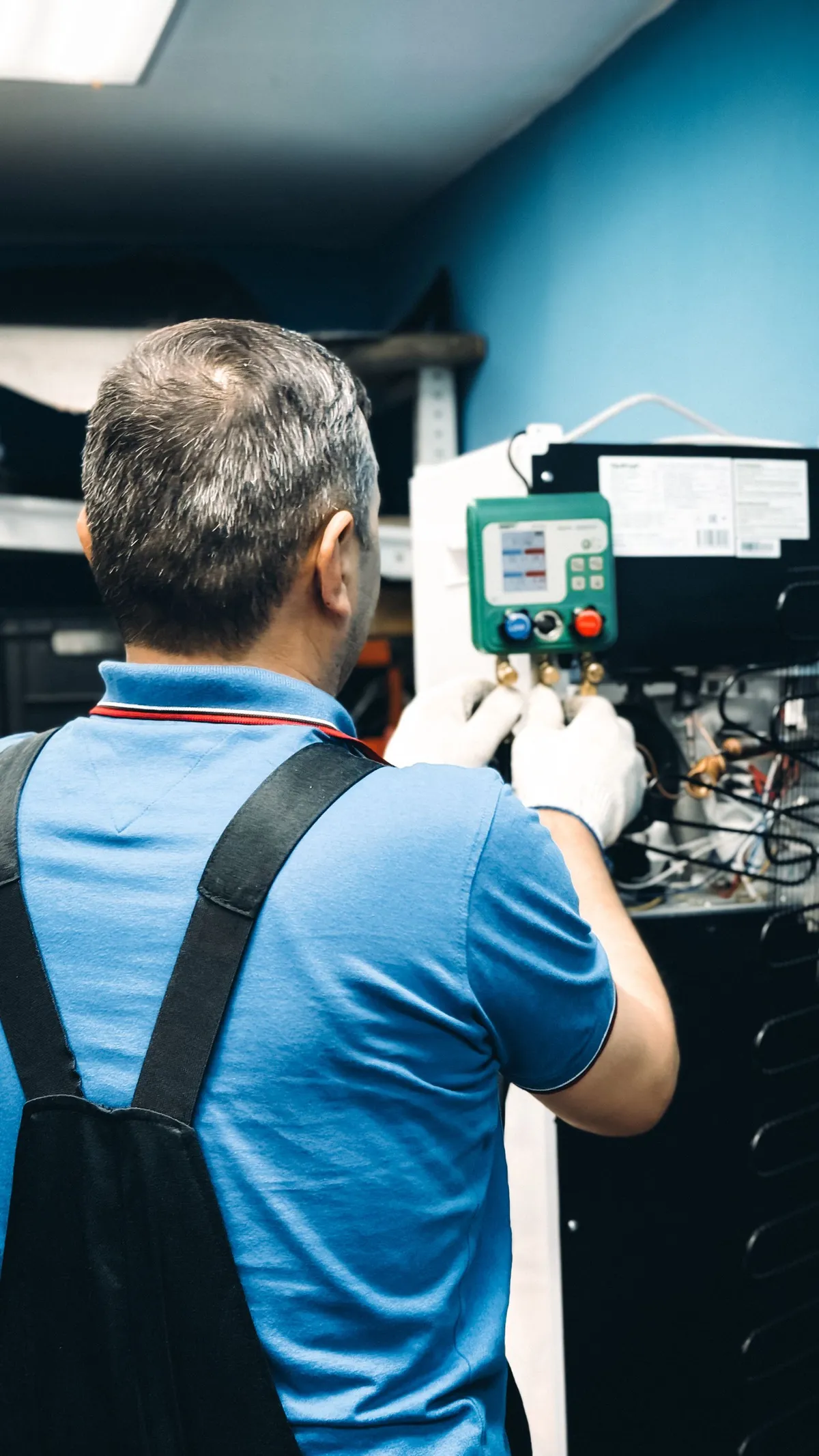 Technician servicing an indoor split system air conditioner