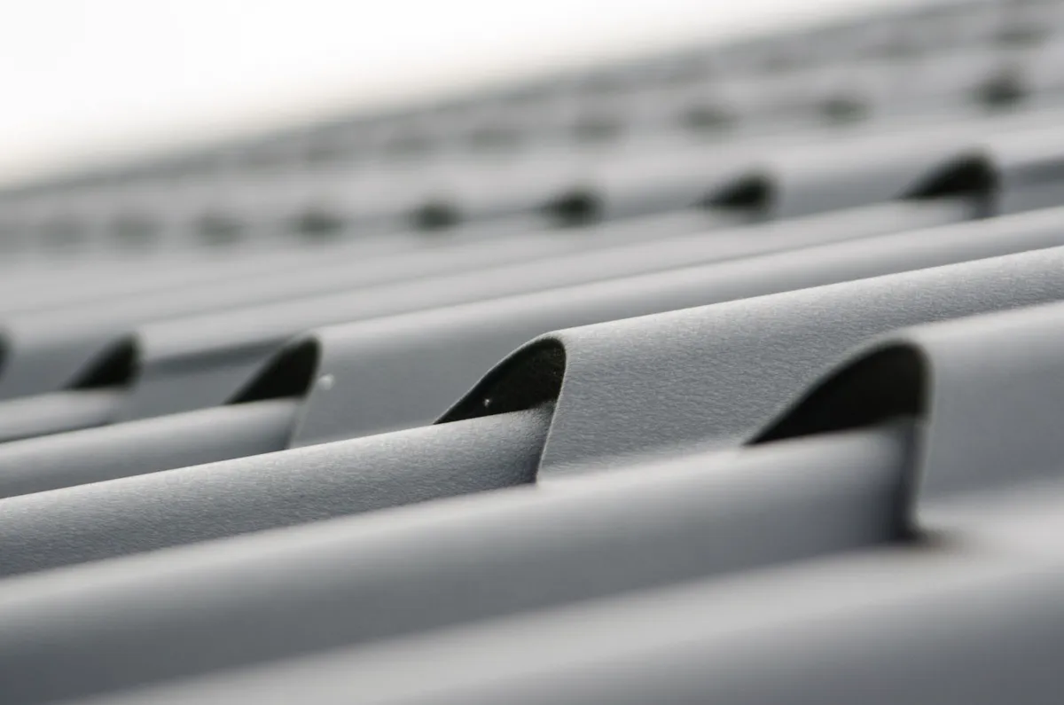 Dark metal roof tiles on a residential building