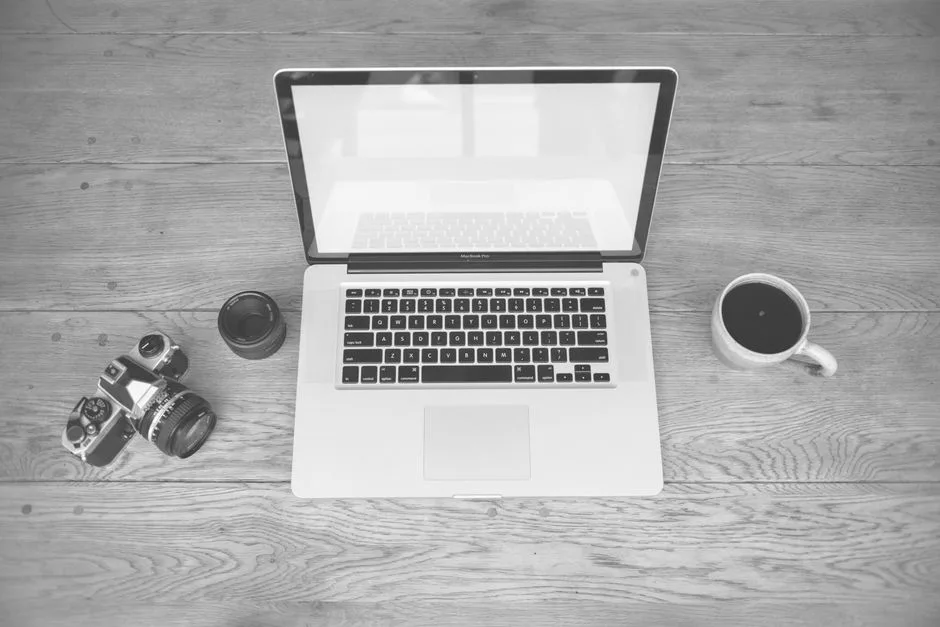 Laptop open on a desk beside a coffee cup during website and SEO work