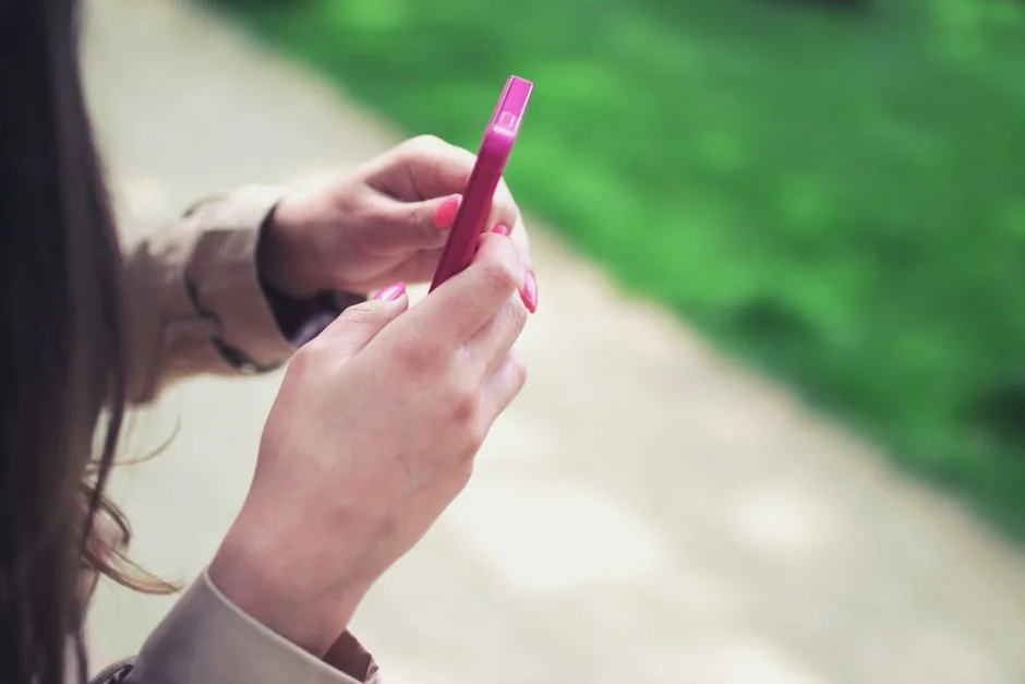 Person typing on a smartphone while searching for a local tradie