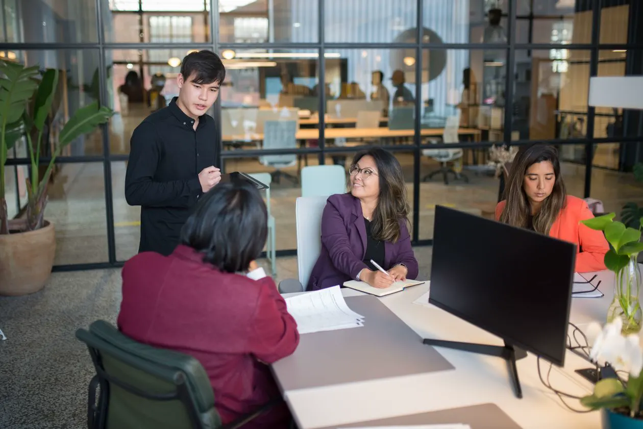 Small team planning a website project around an office table