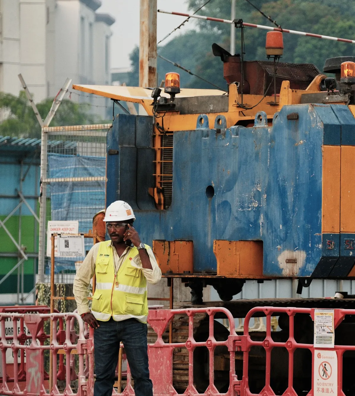 Tradie making a phone call on a job site