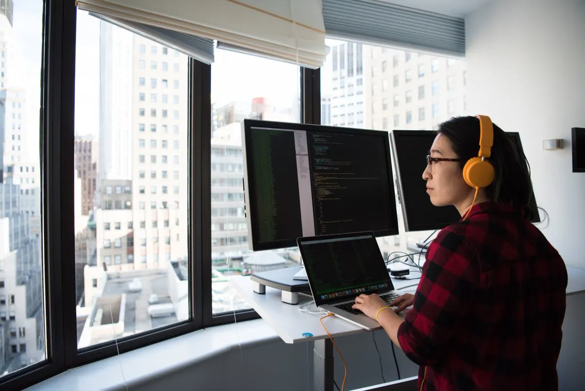 Web developer working on website code at a desk